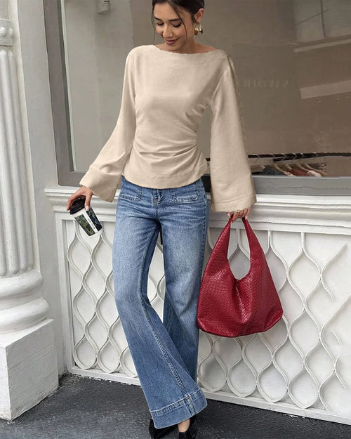 Women wearig beige full sleeve top with back tie detail and flared cuffs, stylish tie back top.