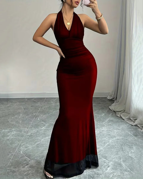 Front view of Red backless maxi dress with halter neckline, body-hugging fit and floor-length silhouette, styled elegantly for evening wear