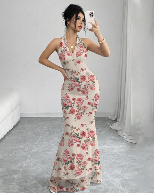 Women wearing Backless floral mermaid maxi dress with mesh halter neckline, fitted silhouette, and flowing hem for evening wear.