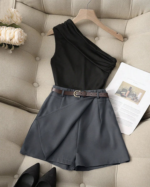 Front view of Black one-shoulder top paired with dark gray high-waist shorts, featuring a stylish belt for a coordinated look.