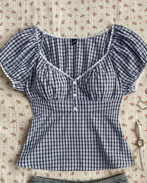 Front view of Chic checkered top for women with puff sleeves and buttoned front, giving a cute fitted shape for everyday styling.