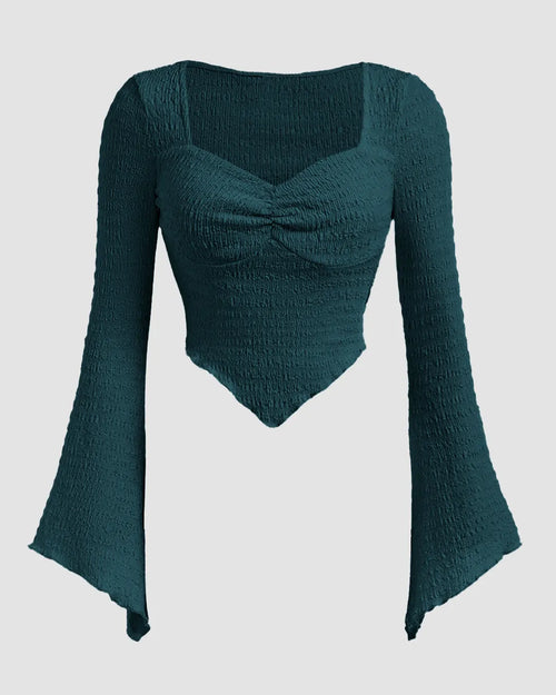 Front view of Teal blue long sleeve top with a textured heart design and flare sleeves, made from soft green knit fabric