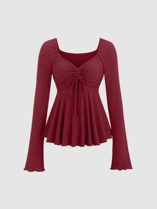 Front view of V-neck drawstring long-sleeve top in maroon with a ruched front and flared hem, crafted from ribbed fabric