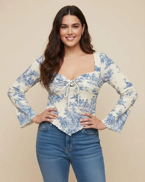 Women wearing a girls bell sleeve top with floral print, tie front detail and asymmetrical hem for a soft feminine look.