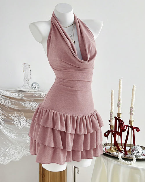 Side view of dusty pink halter neck dress with cowl neckline and tiered ruffle hem, featuring a fitted silhouette and soft feminine look