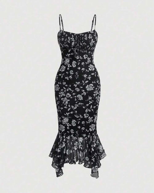 Front view of black and white floral dress featuring spaghetti straps and a ruched bust, designed in a mermaid silhouette