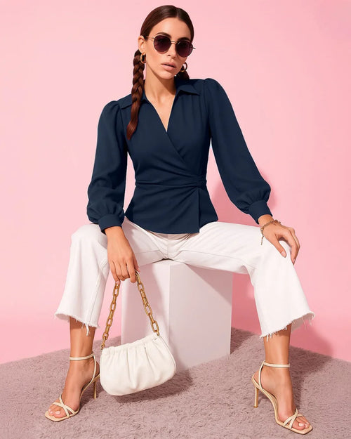 Women wearing v-neck navy blue wrap top with dramatic lantern sleeves and a cinched waist for a structured, elegant silhouette.