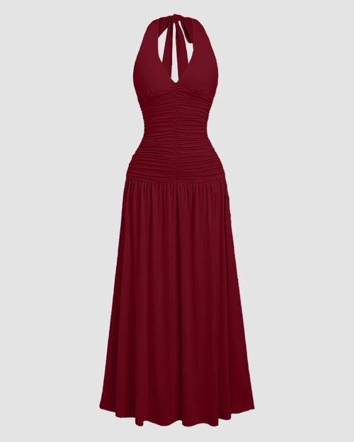 Front view of Maroon halter neck backless maxi dress with ruched bodice and flared skirt, featuring a flowy elegant silhouette