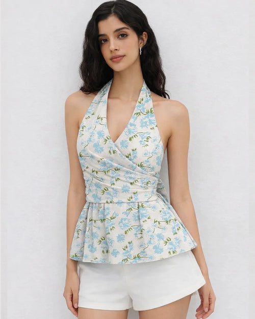 Women wearing white floral halter neck top with knotted waist and flared hem, stylish white floral top.