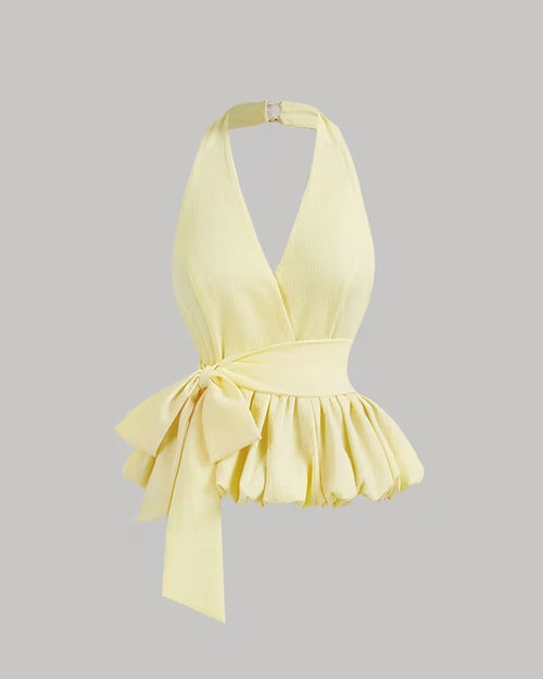Front view of yellow halter neck sleeveless top with ruffle hem and tie waist detail, stylish yellow colour top.