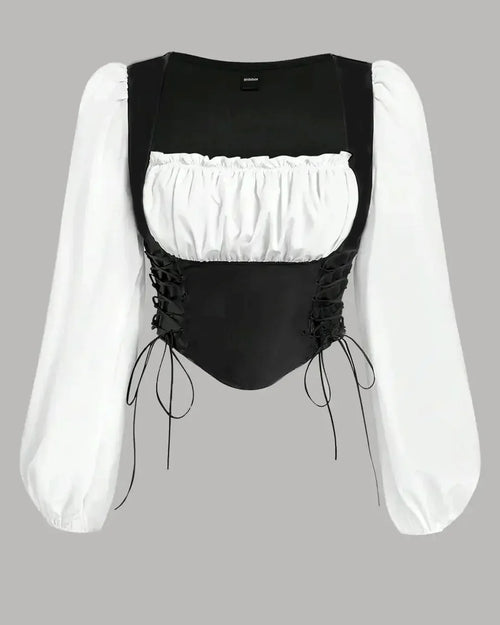 Front view of Vintage black and white corset top featuring ruffled lantern sleeves, showcasing a stylish and elegant design.