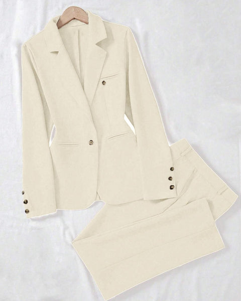 Flat-lay of an off-white jacket and pant set featuring a tailored button blazer with notched lapel and matching straight-leg trousers, styled on a clean white background for a minimal look.