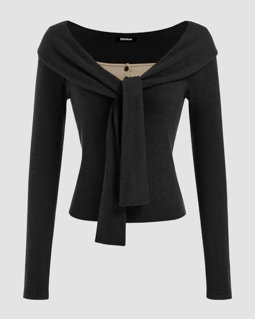 Front view of Black off-shoulder long sleeve crop top with a slim fit silhouette, straight hem, and solid finish for a chic look.