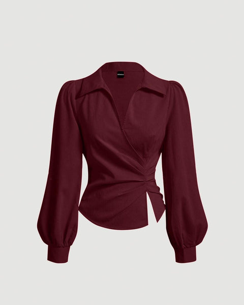 Front view of burgundy made from soft, lightweight fabric featuring a V-neck, wrap front, and lantern long sleeves