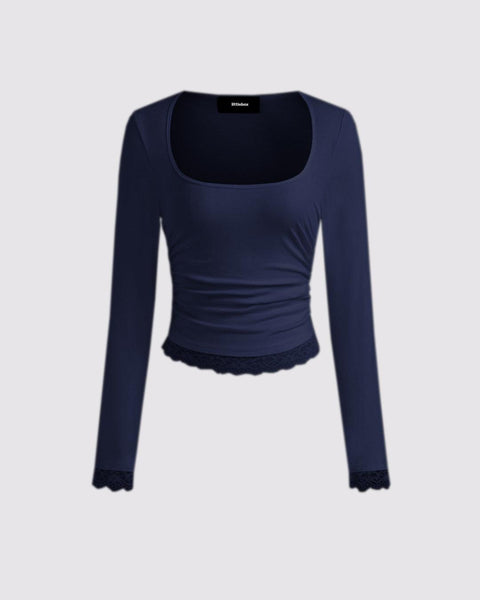 Navy blue long sleeve crop top with a square neck, made from soft knit fabric and featuring a lace bottom detail.