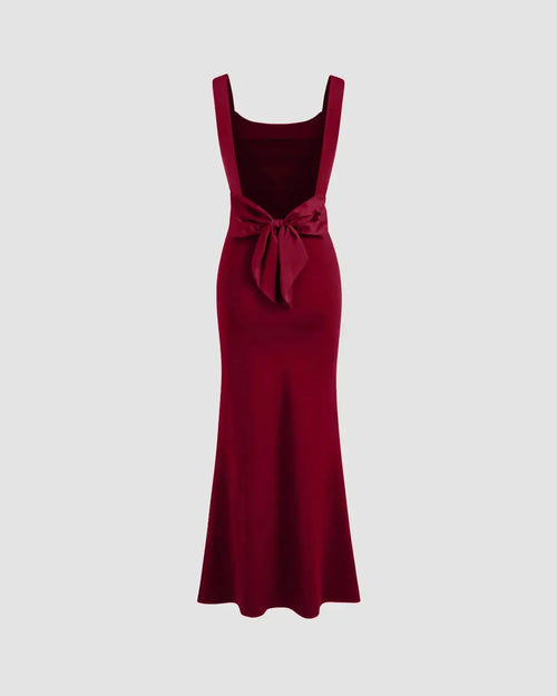 A burgundy bodycon dress featuring a scoop neckline and a bowknot detail on the back