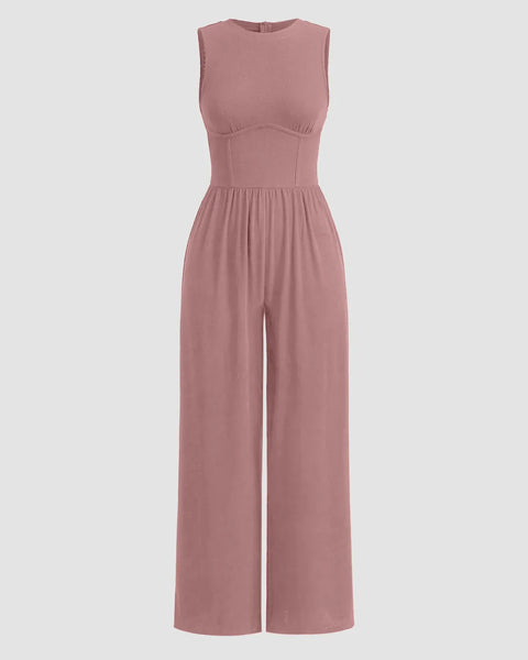 Dusty pink sleeveless jumpsuit with gathered waist and wide legs, made from soft, lightweight fabric.