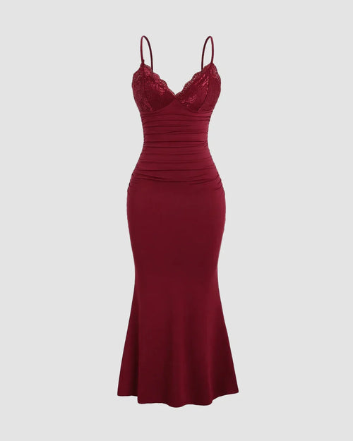 Deep maroon bodycon dress with lace cups, adjustable straps, ruched bodice, and a flowing fishtail hem for a dramatic look