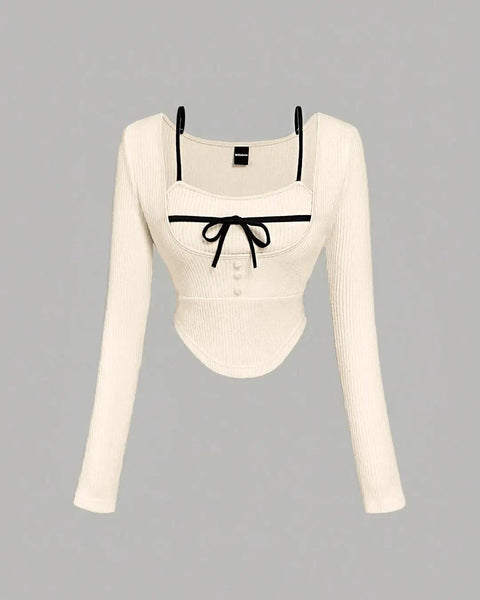 Front view of Off-white long sleeve sweater featuring black trimming along the edges.