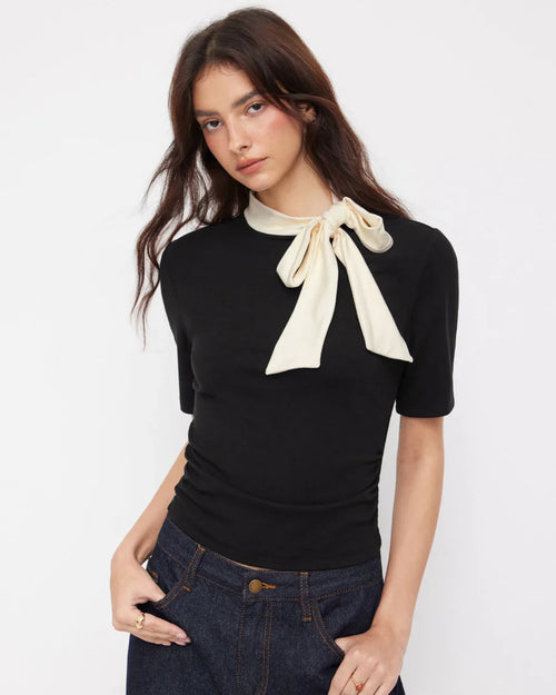 Women wearing Black ruched top with stand collar and bowknot detail, fitted silhouette with short sleeves and clean hem finish