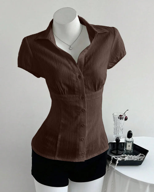 Front view of Womens collared shirt in coca brown with V-neck and waist-cinched fit, textured fabric and short sleeves