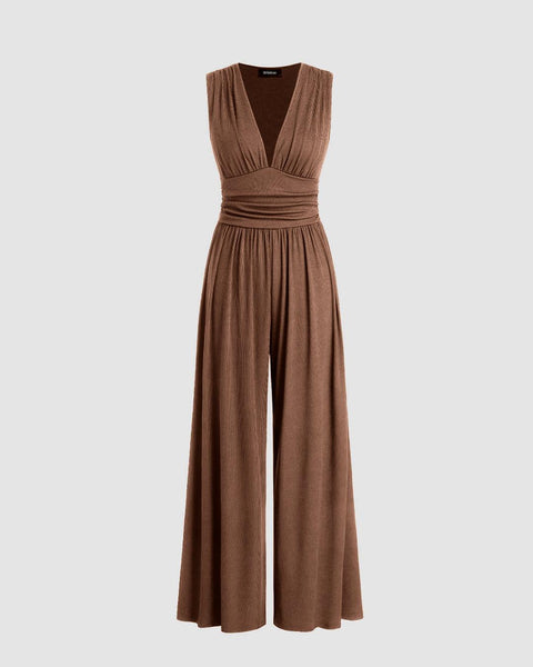 A brown jumpsuit featuring a V-neckline and a tie-back detail for an adjustable fit.