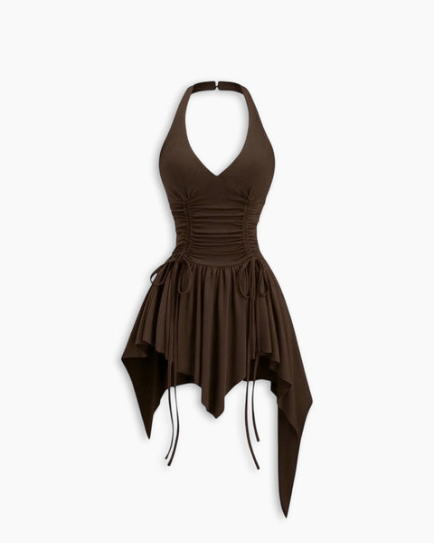 Front view of brown mini dress with halter neck, cinched waist and asymmetric hem for a stylish edgy look.