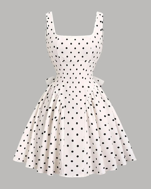 Front view of white polka dot mini dress with square neck, flared skirt and bow back detail, cute bow dress for women.