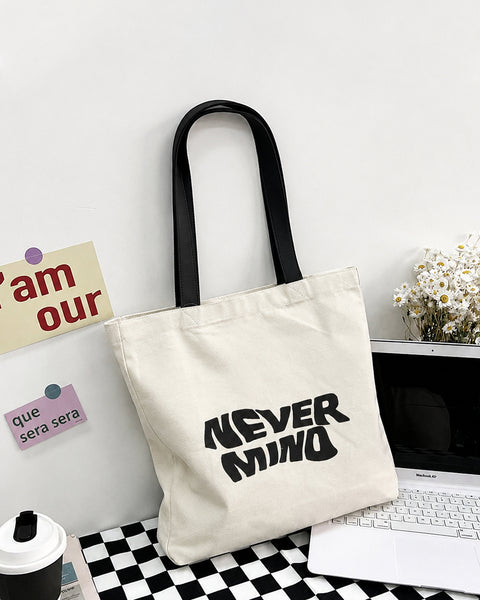 Never Mind Graphic Canvas Tote Bag in Jet White