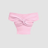 Baby pink off-shoulder crop top with a twisted front detail, soft ribbed knit fabric, and a slim fit silhouette. Sleeveless design highlights the collarbones, offering a stylish and comfortable look.