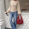 Women wearig beige full sleeve top with back tie detail and flared cuffs, stylish tie back top.