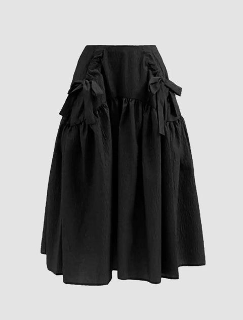 A black skirt featuring a decorative bow at the waist