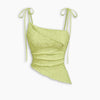 Front view of lemon yellow top with asymmetric hem, tie strap shoulders and textured fabric for a fitted look.