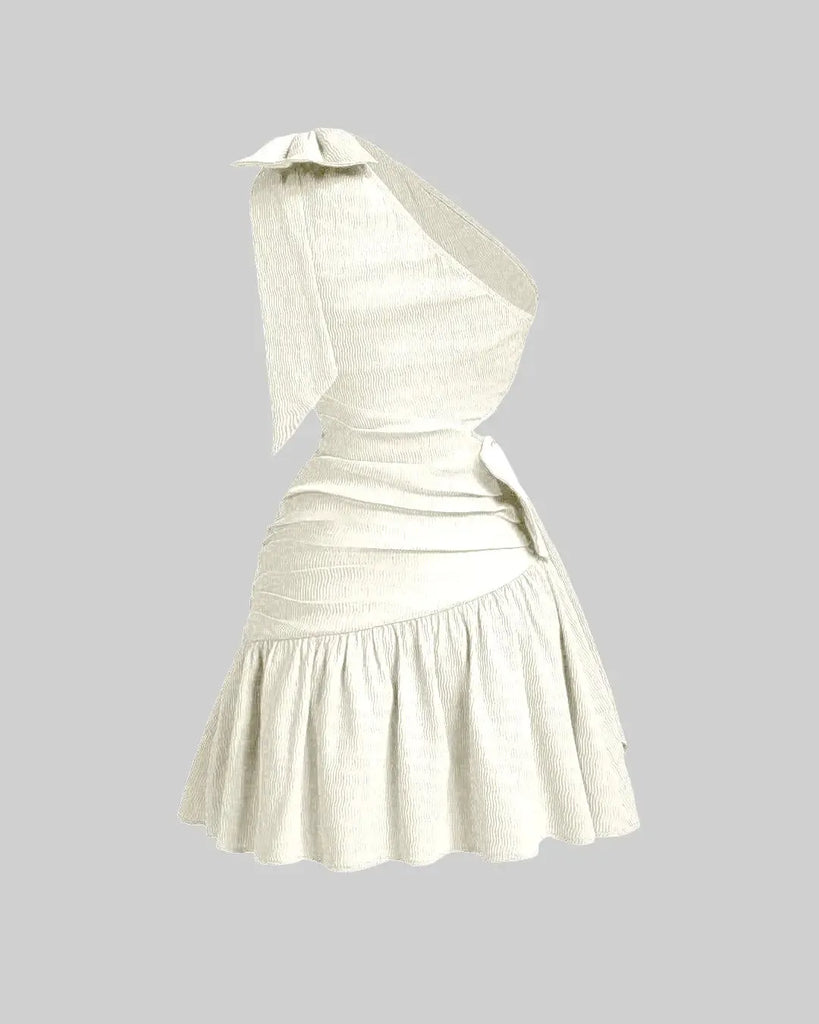 Back of an off-white mini dress featuring an asymmetrical neckline, bow tie detail, and a cropped waist for a modern, structured silhouette.