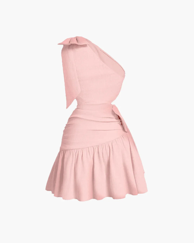 Powder pink mini dress featuring an asymmetrical neckline, bow-tie detail, and a cropped waist for a bold, sculpted silhouette.
