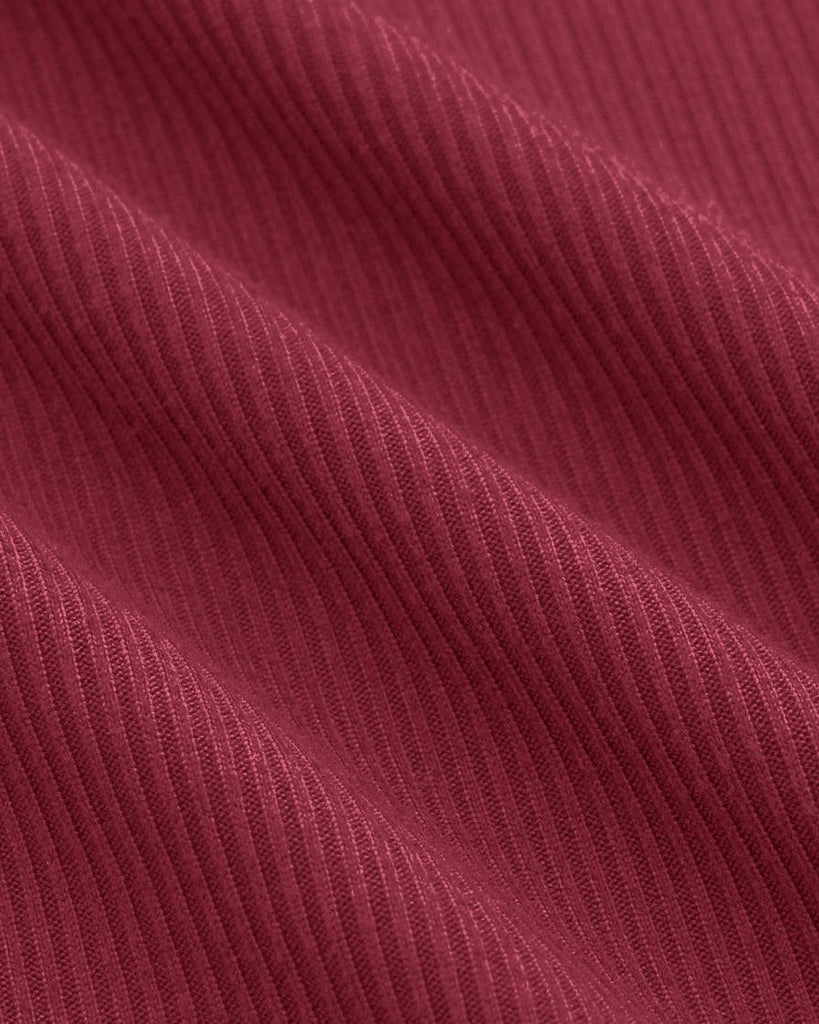 maroon mini dress featuring an asymmetrical neckline and long sleeves