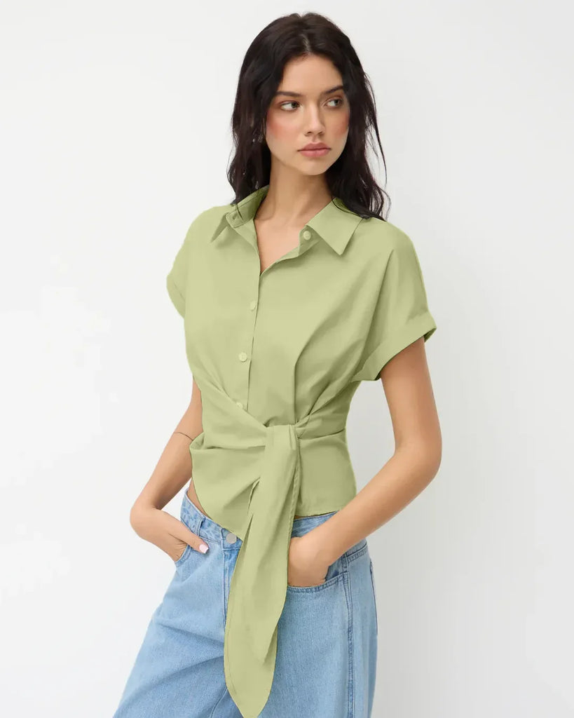 Women's green polo shirt with a front knot, featuring an asymmetrical tie waist design in herbal color.