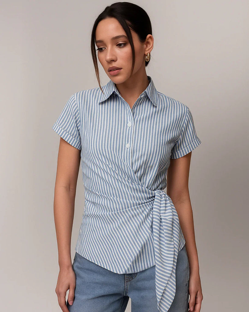 Close view of blue and white striped asymmetrical wrap front shirt with a stylish knot detail at the waist