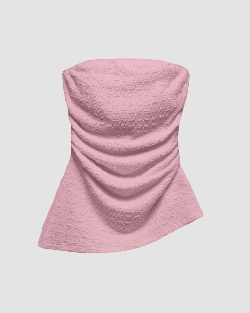 Ruched Baby pink tube top with an asymmetric hem, featuring a soft, textured design that flatters and adds a flirty touch