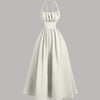Cream halter-neck midi dress with a back tie and gathered detailing for a soft, elegant drape.