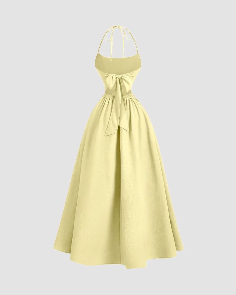 Back view of a Yellow Back Tie Halter Neck Gathered Midi Dress featuring a ruffled neckline, styled in French Vanilla.