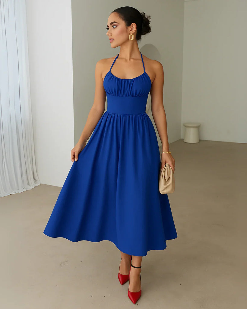 A gathered midi dress in surf blue featuring a stylish stop neck and back tie halter design.
