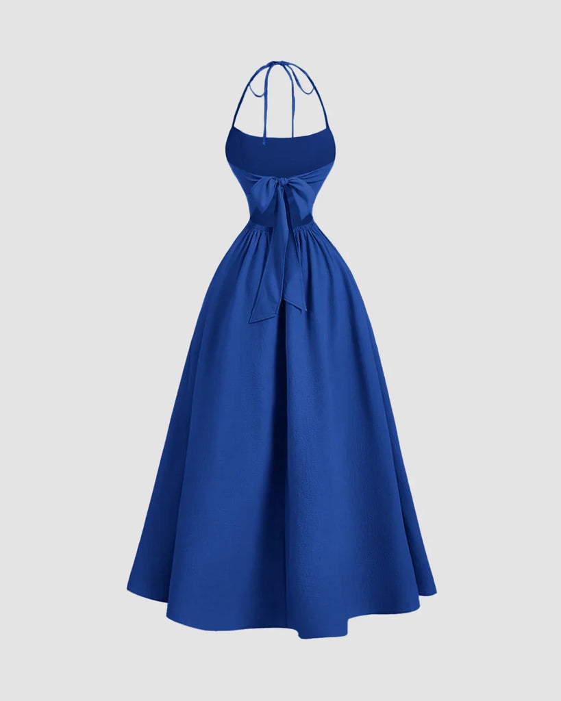 Back view of a gathered midi dress in surf blue featuring a stylish stop neck and back tie halter design.
