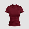 Burgundy slim fit top with a round neckline and subtle ruching at the waist, designed for comfort and a flattering silhouette