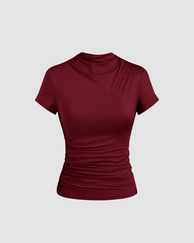 Burgundy slim fit top with a round neckline and subtle ruching at the waist, designed for comfort and a flattering silhouette