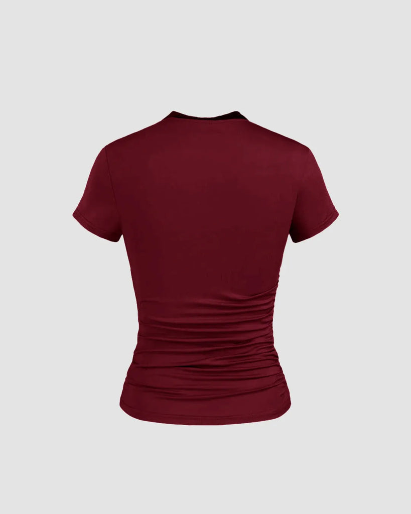 Back of Burgundy slim fit top with a round neckline and subtle ruching at the waist, designed for comfort and a flattering silhouette