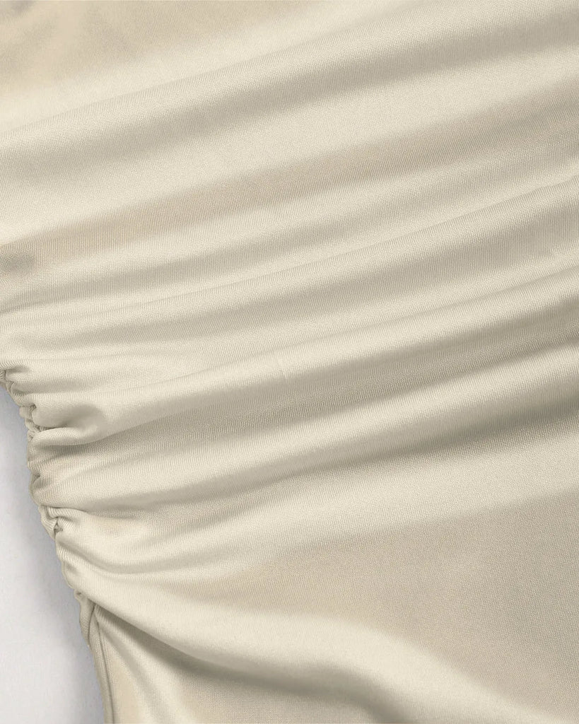 Elegant beige off-shoulder midi dress with a fit and flare silhouette, crafted from soft fabric.