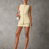 Front view of Beige sleeveless top and mini skirt set with front button detail, fitted shape, and clean tailored summer look.