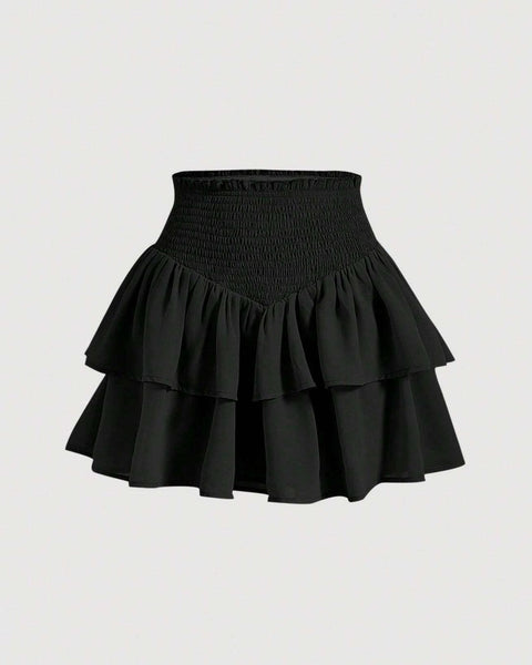 A black skirt featuring a ruffled hem, elegantly draping and adding a stylish touch to the overall design