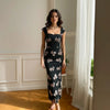 Front view of Black and white floral maxi dress with a square neckline and cap sleeves, featuring a fitted bodice and flowing silhouette.